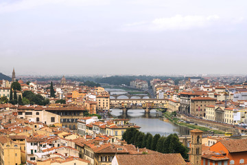 Naklejka na ściany i meble Top panoramic cityscape view of old town Florence city, Tuscany region, riverside of Arno river and Ponte vecchio bridge during raining and cloudy from Piazzale Michelangelo in Florence, Italy