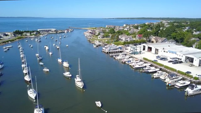 Aerial View of Numerous Anchored Boats in Falmouth Inner Harbor in Cape Cod Massachusetts, Flying Towards the Ocean on a Beautiful Day