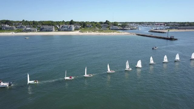 A Sailing Instructor Leads a Line of Students in Sailboats out on the Water along Cape Cod, Massachusetts