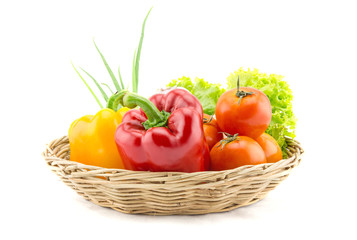 Organic vegetables in the wicker basket on white background