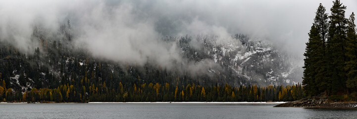 autumn panorama of Payette Lake with clouds and snow