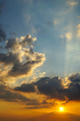 Naklejka na ściany i meble Sunset rays with clouds