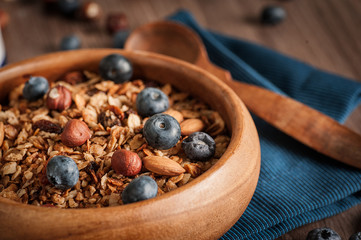 Homemade Granola with blueberries in a wooden bowl