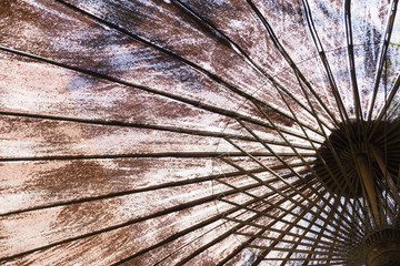 View of close up textile umbrella with bamboo stick as pattern line and background