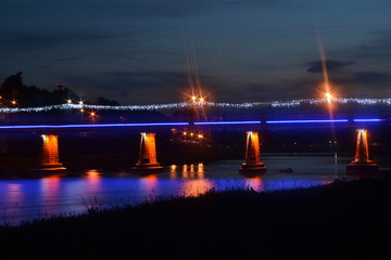 Bridge against river Uzh at night