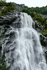 Fototapeta na wymiar Beautiful high waterfall in swiss Alps, summer