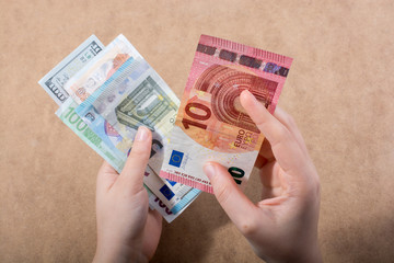 Hand holding American dollar  isolated on wooden background