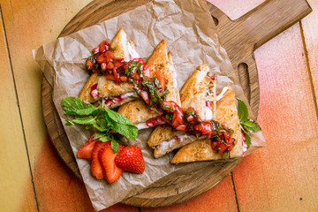 Sweet sandwich with raspberry sauce