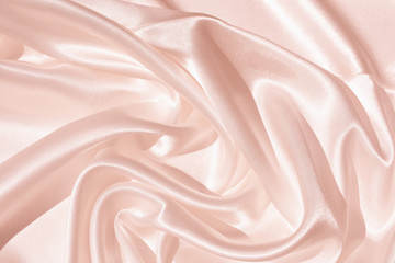 The texture of the satin fabric of pink color for the backgroundит