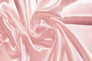 The texture of the satin fabric of pink color for the backgroundит