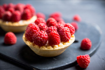 Rasberry cake decorated with fresh ripe berries on the rustic background. Selective focus. Shallow depth of field.