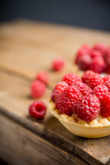 Rasberry cake decorated with fresh ripe berries on the rustic background. Selective focus. Shallow depth of field.