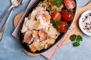 Slices of fried fish with vegetables