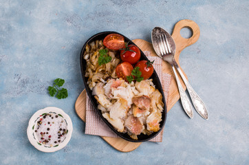 Slices of fried fish with vegetables