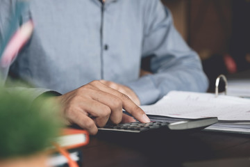 Businessman working with financial documents and calculator in office. Business analysis and strategy concept.