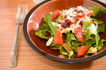 Fresh salad with strawberries on table