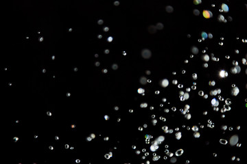 bokeh of water drops levitating in the air reflection