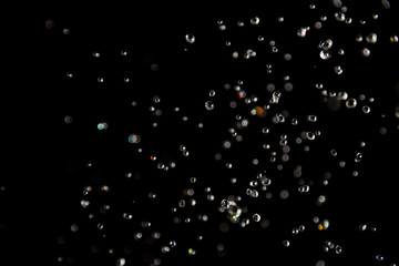 bokeh of water drops levitating in the air reflection