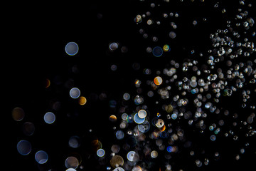 bokeh of water drops levitating in the air reflection