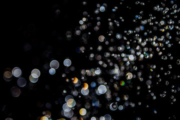 bokeh of water drops levitating in the air reflection