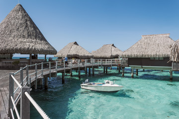 Over water bungalow and a boat in Moorea, French Polynesia