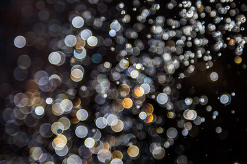bokeh of water drops levitating in the air reflection