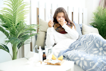 ill young girl with fever spending time at home