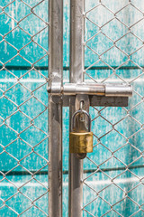 metal fence  is unlock with a gold keychain