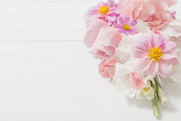 flowers in waffle cone on wooden background