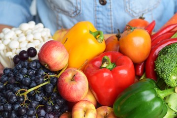 colorful vegetable in wood tray carry by boy hands wear blue jeans shirt, organic garden or healthy clean food vitamin concept with copy space