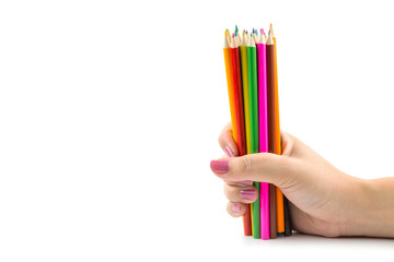 Colored pencils in female hand on white