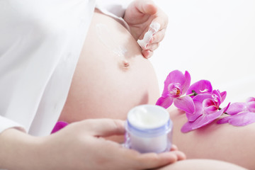 pregnant woman with cosmetic cream