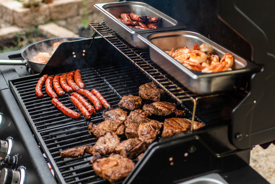 Barbecue grill bbq on propane gas grill steaks bratwurst sausages meat meal