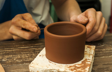 Fototapeta na wymiar The potter works in a workshop