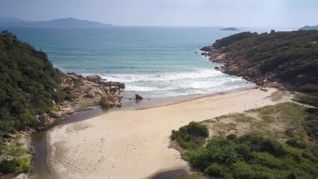 drone shows lagoon sandy beach on rocky coast
