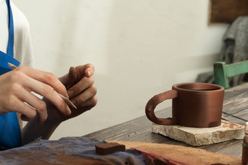 Naklejka na ściany i meble The potter works in a workshop