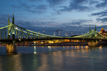 Fototapeta na wymiar Liberty Bridge in Budapest Hungary at night with a nice cloudy sky