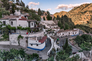 View over the famous Sacromonte in Granada, Andalucia, Spain. Moorish achtitecture, cave houses opposite to the Alhambra palace and next to Albaicín. - obrazy, fototapety, plakaty