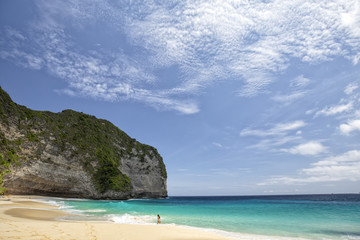 A relaxing sunny day at the amazing Kelingking Beach on Nusa Penida in Indonesia. - obrazy, fototapety, plakaty