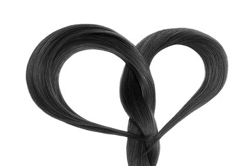 Long black hair in shape of heart on white background. Hair care concept 