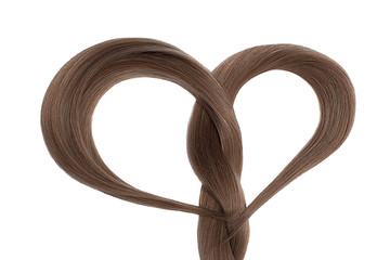 Long brown hair in shape of heart on white background. Hair care concept 