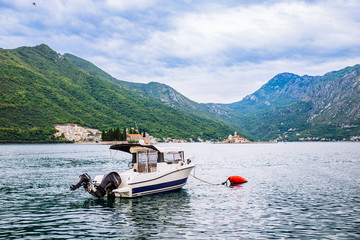 boat in kotor bay. beautiful sea with mountains on background