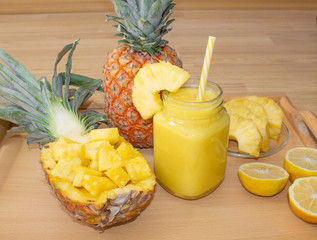 Still life. Pineapple juice, smoothies with fresh pineapple for breakfast in the morning on a wooden table. Detox. For health and for losing weight.