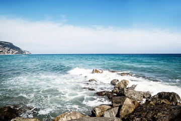 Pebble beach and blue sky on background