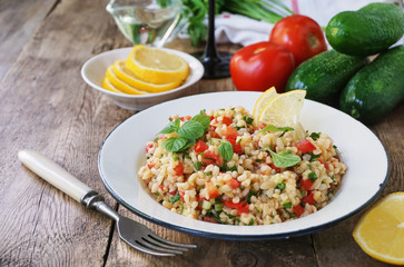 Salad with bulgur, tomatoes, cucumbers and fresh herbs