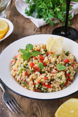 Salad with bulgur, tomatoes, cucumbers and fresh herbs