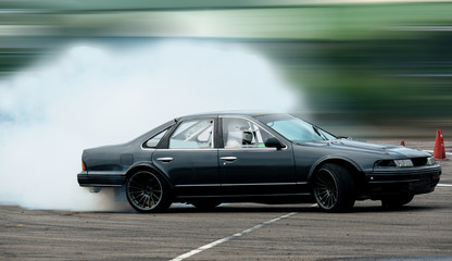 Sport car wheel drifting. Blurred of image diffusion race drift car with lots of smoke from burning tires on speed track. Sport concept,Drifting car concept © applezoomzoom