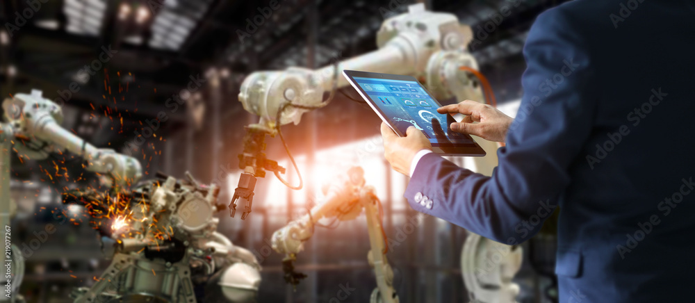 Aufkleber Industrial manager, engineer using tablet checking and controlling automation robot arms machine in intelligent factory industrial on monitoring system software.