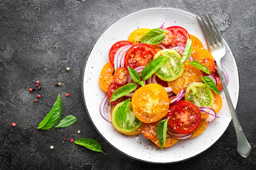 Tomato salad. Fresh vegetable salad with tomatoes, onion and basil