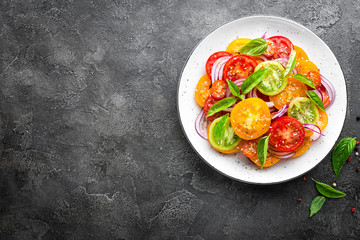 Tomato salad. Fresh vegetable salad with tomatoes, onion and basil
